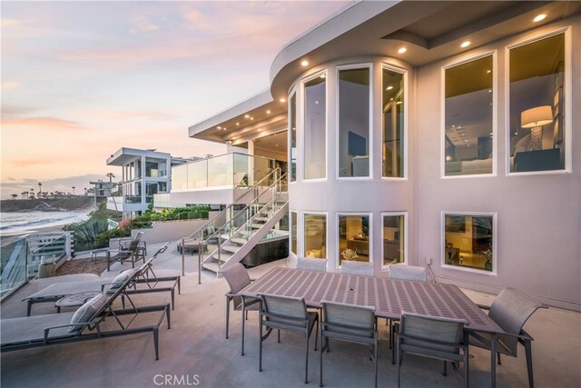 31091 Coast Hwy, Laguna Beach, CA 92651 - patio terrace at dusk featuring outdoor dining space and stairs
