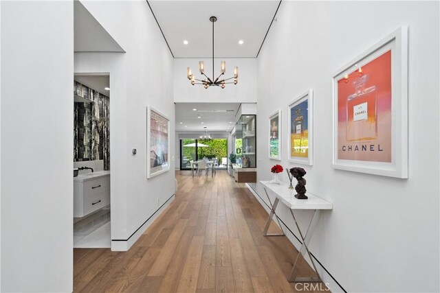 4739 Ventura Canyon Ave, Sherman Oaks, CA 91423 - hall with hardwood / wood-style floors, recessed lighting, an inviting chandelier, and baseboards