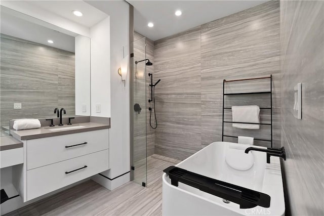 4739 Ventura Canyon Ave, Sherman Oaks, CA 91423 - full bathroom featuring recessed lighting, a tile shower, tile walls, vanity, and a soaking tub