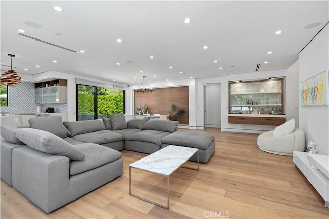 4739 Ventura Canyon Ave, Sherman Oaks, CA 91423 - living room featuring light wood-type flooring, recessed lighting, and a notable chandelier