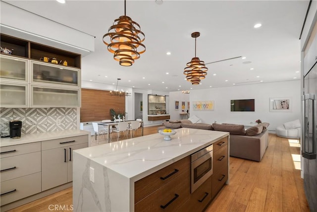 4739 Ventura Canyon Ave, Sherman Oaks, CA 91423 - kitchen with recessed lighting, hanging light fixtures, stainless steel microwave, a chandelier, and modern cabinets