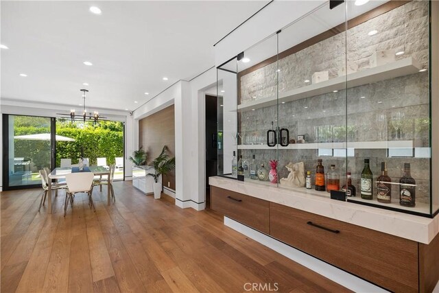 4739 Ventura Canyon Ave, Sherman Oaks, CA 91423 - bar with recessed lighting, a bar, wood-type flooring, a notable chandelier, and pendant lighting