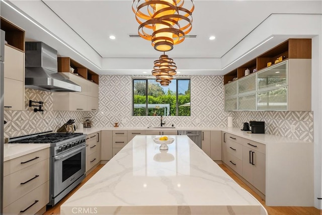 4739 Ventura Canyon Ave, Sherman Oaks, CA 91423 - kitchen featuring light stone counters, a chandelier, stainless steel appliances, open shelves, and wall chimney exhaust hood