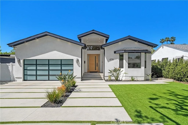 4739 Ventura Canyon Ave, Sherman Oaks, CA 91423 - view of front of property with stucco siding, concrete driveway, a front yard, and an attached garage