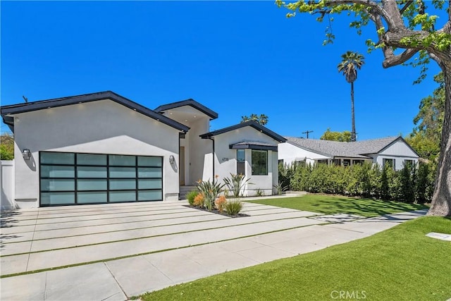 4739 Ventura Canyon Ave, Sherman Oaks, CA 91423 - view of front facade with a front lawn, driveway, a garage, and stucco siding