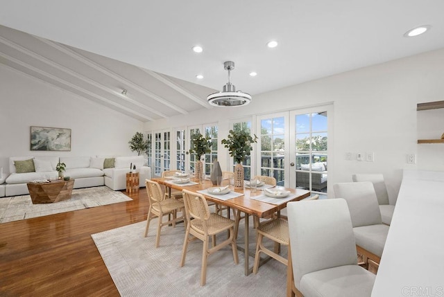 dining area with lofted ceiling with beams, french doors, wood finished floors, and recessed lighting