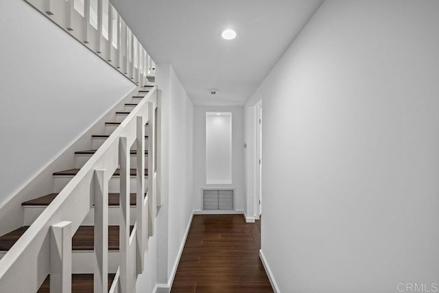 corridor with dark wood-style flooring, baseboards, visible vents, recessed lighting, and stairs