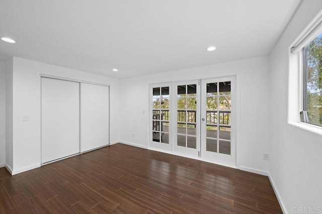unfurnished bedroom with wood finished floors, access to exterior, and recessed lighting