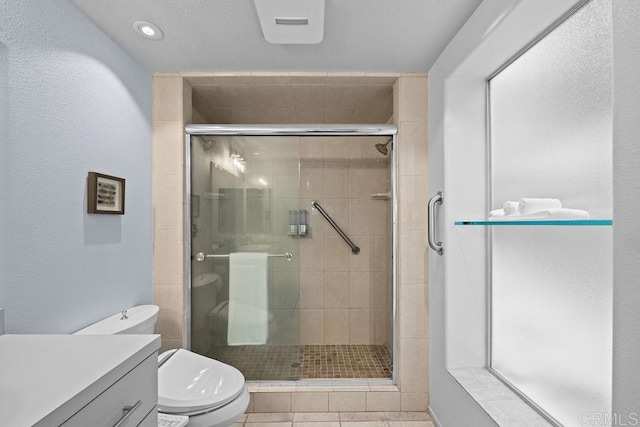 full bathroom featuring tile patterned flooring, toilet, vanity, and a stall shower