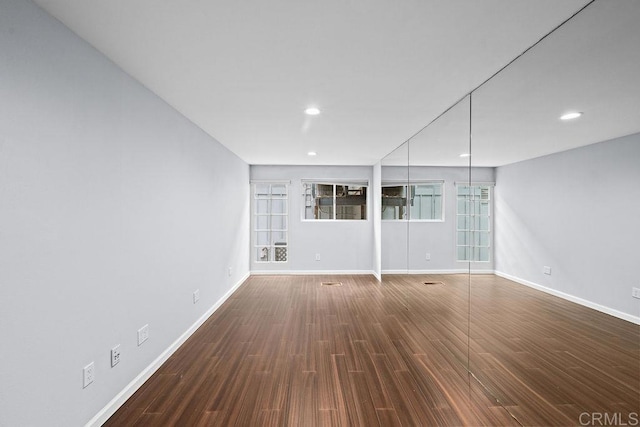 interior space featuring wood finished floors, baseboards, and recessed lighting