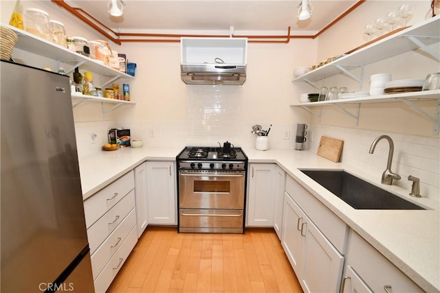16700 Yukon Ave Unit 204, Torrance, CA 90504 - kitchen featuring a sink, open shelves, light wood-style flooring, and appliances with stainless steel finishes