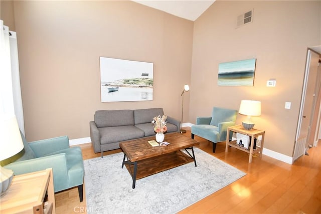 16700 Yukon Ave Unit 204, Torrance, CA 90504 - living area featuring vaulted ceiling, visible vents, light wood-type flooring, and baseboards