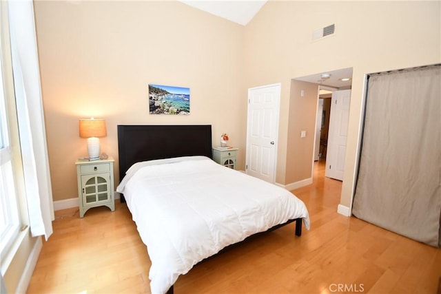16700 Yukon Ave Unit 204, Torrance, CA 90504 - bedroom with light wood-style flooring, high vaulted ceiling, baseboards, and visible vents