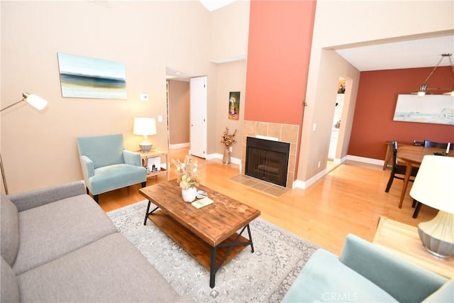 16700 Yukon Ave Unit 204, Torrance, CA 90504 - living room featuring baseboards, a high ceiling, wood finished floors, and a fireplace