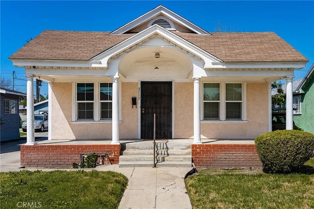 5717 4th Ave, Los Angeles, CA 90043 - view of front of property featuring a porch, a shingled roof, and stucco siding