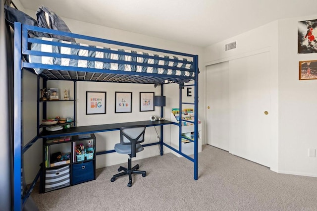 carpeted bedroom featuring a closet, baseboards, and visible vents