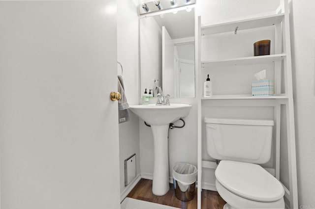 bathroom with toilet and wood finished floors