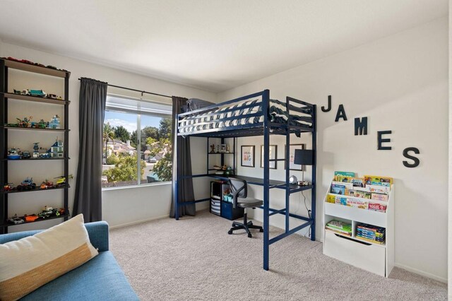carpeted bedroom featuring baseboards
