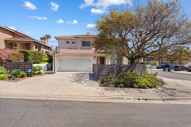 view of front of property featuring driveway, stucco siding, an attached garage, and a tile roof