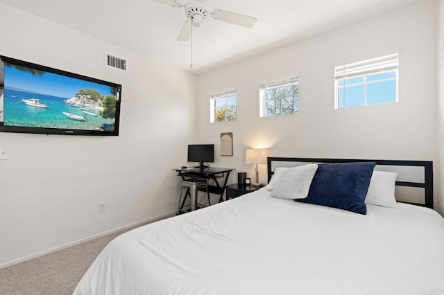 carpeted bedroom with ceiling fan, baseboards, and visible vents