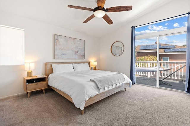 carpeted bedroom featuring access to exterior and ceiling fan