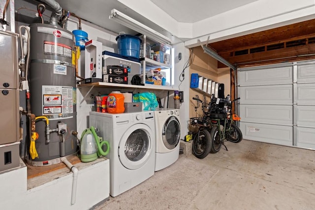 garage featuring water heater and separate washer and dryer