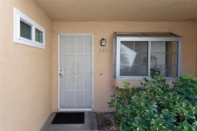 entrance to property with stucco siding