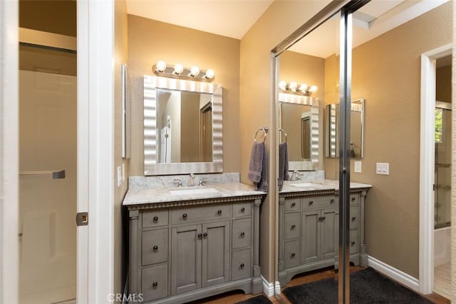 full bathroom with baseboards and vanity