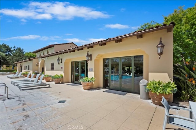 374 Quail Rdg, Irvine, CA 92603 - rear view of house with a patio area and stucco siding