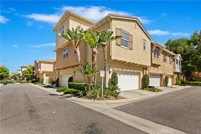 374 Quail Rdg, Irvine, CA 92603 - view of front of home featuring an attached garage, a residential view, and stucco siding
