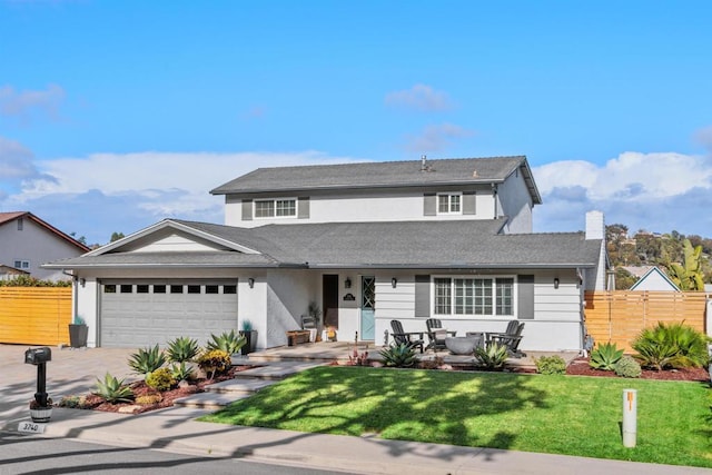 traditional home featuring fence, a garage, stucco siding, and a front lawn