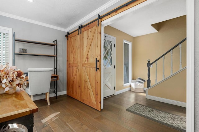 foyer with stairway, wood-type flooring, a barn door, and baseboards