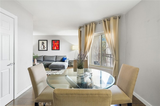dining room featuring baseboards and wood finished floors
