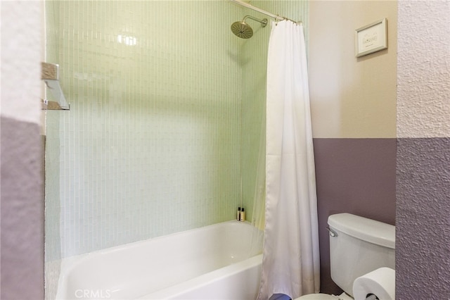 bathroom featuring shower / tub combo with curtain and toilet