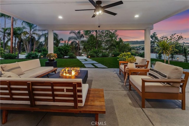 32152 Via Carlos, San Juan Capistrano, CA 92675 - patio terrace at dusk with an outdoor living space with a fire pit, a patio, a ceiling fan, and a yard