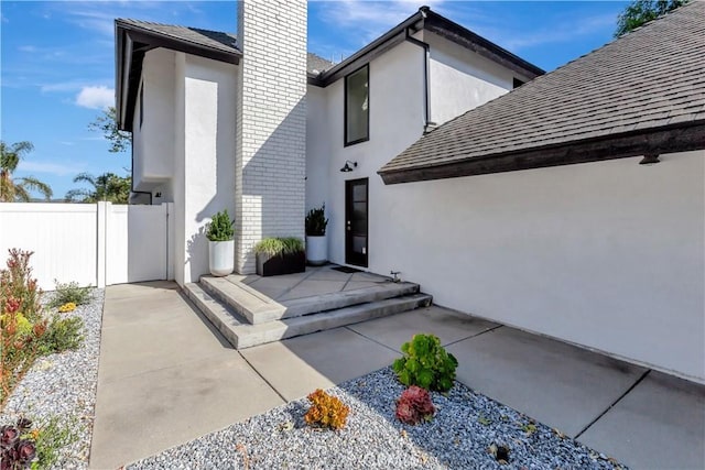 32152 Via Carlos, San Juan Capistrano, CA 92675 - rear view of property featuring stucco siding, a shingled roof, a chimney, and brick siding