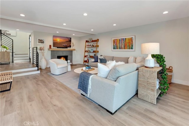 32152 Via Carlos, San Juan Capistrano, CA 92675 - living area with wood finished floors, recessed lighting, a warm lit fireplace, and stairs