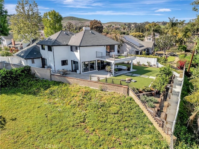 32152 Via Carlos, San Juan Capistrano, CA 92675 - rear view of house with a balcony, stucco siding, a fenced backyard, and a patio