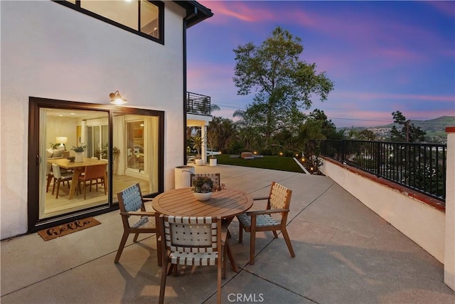 32152 Via Carlos, San Juan Capistrano, CA 92675 - patio terrace at dusk featuring outdoor dining space, a balcony, and a patio