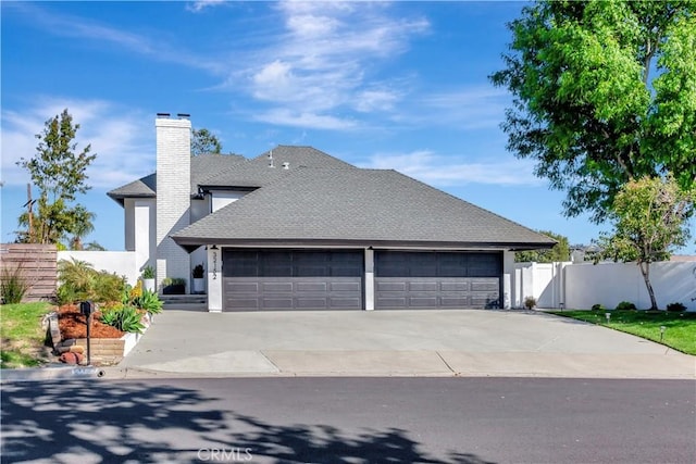 32152 Via Carlos, San Juan Capistrano, CA 92675 - view of property exterior with a chimney, a garage, driveway, and roof with shingles