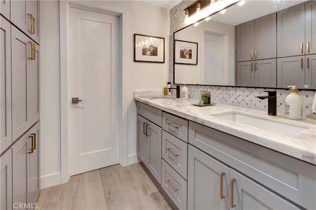 32152 Via Carlos, San Juan Capistrano, CA 92675 - bathroom featuring double vanity, wood finished floors, and decorative backsplash