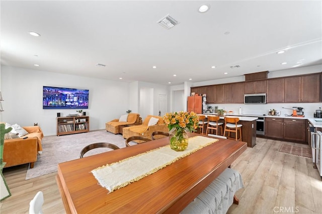 dining room featuring recessed lighting, light wood-style floors, and visible vents