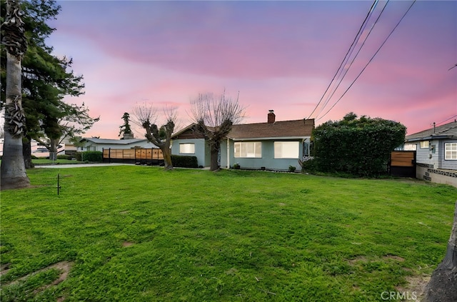 916 Stearns St, Calimesa, CA 92320 - view of front facade featuring fence, a lawn, and a chimney