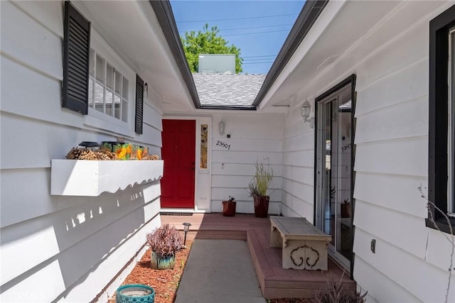 doorway to property featuring a shingled roof