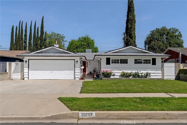 ranch-style home with fence, concrete driveway, a front yard, and an attached garage