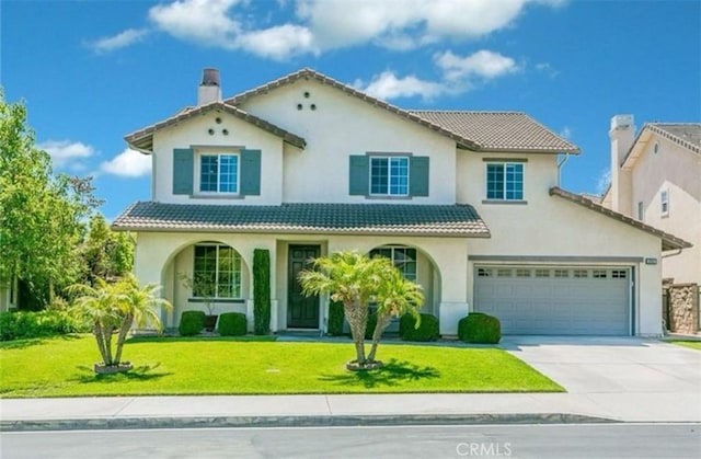 16801 Carob Ave, Chino Hills, CA 91709 - mediterranean / spanish home featuring concrete driveway, a front lawn, a tiled roof, and a chimney