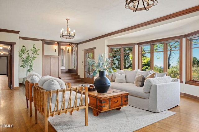402 Lynn Dr, Ventura, CA 93003 - living area with crown molding, a wealth of natural light, an inviting chandelier, and wood finished floors
