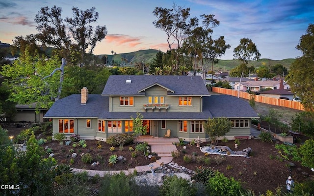 402 Lynn Dr, Ventura, CA 93003 - view of front of home featuring a mountain view, fence, and a chimney