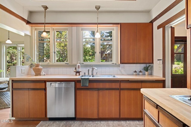 402 Lynn Dr, Ventura, CA 93003 - kitchen featuring light countertops, decorative backsplash, stainless steel dishwasher, a sink, and hanging light fixtures
