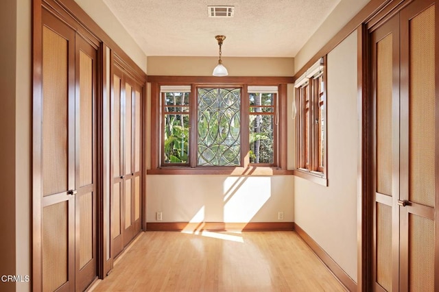 402 Lynn Dr, Ventura, CA 93003 - interior space with light wood-style floors, visible vents, a textured ceiling, and baseboards